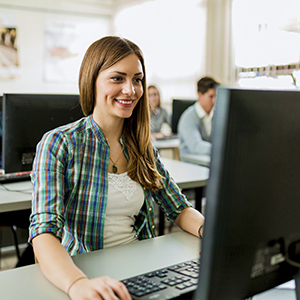 A young lady at her office very happy to be at work.